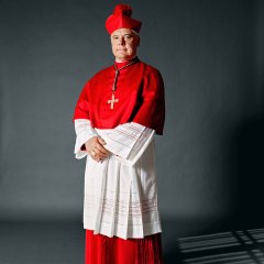 aus der Serie „Kleider machen Leute“

Porträt von Gerhard Ludwig Müller, Bischof, Deutschland, 2012, in Dienstkleidung

„Als ich zum ersten Mal das Priestergewand trug, war ich am Ziel meiner Wünsche angekommen. Am Anfang war ich noch ein bisschen ungelenk in der Soutane, weil man es nicht gewohnt ist, in so langen Kleidern zu gehen, das müssen wir als „Hosenträger“ erst lernen. Auch musste ich mich erst daran gewöhnen, dass mich die Menschen im Bischofskleid nicht als Privatperson sehen, sondern als Priester. Die Priesterkleidung mit entsprechendem Kragen ist wichtig, weil sich darin eine Lebensentscheidung zeigt. In ihr habe ich bewusst mehr Haltung und einen aufrechten Gang.“