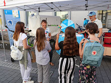 Menschen stehen an einem Infostand